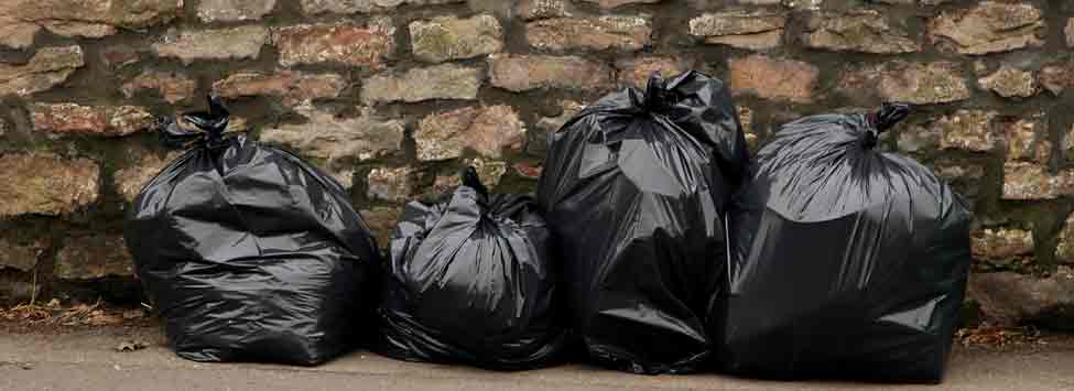 full black bags on brick wall